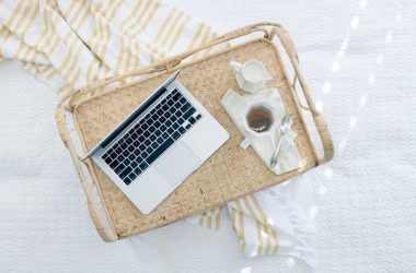 gray laptop computer on beige wicker chair