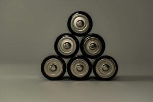 Metallic AA batteries stacked in a pyramid shape, symbolizing power and energy storage.