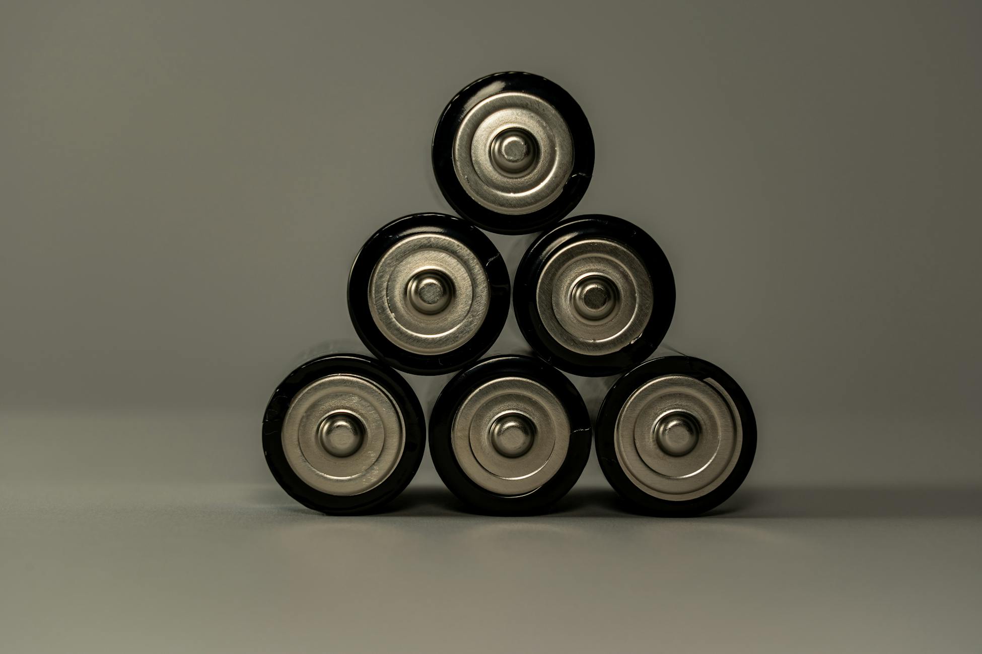 Metallic AA batteries stacked in a pyramid shape, symbolizing power and energy storage.