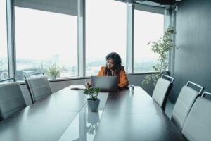 Professional woman sitting alone in conference room