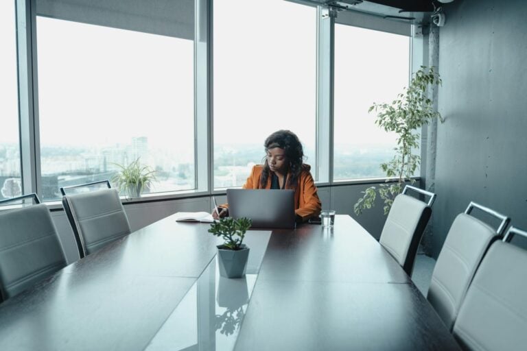 Professional woman sitting alone in conference room