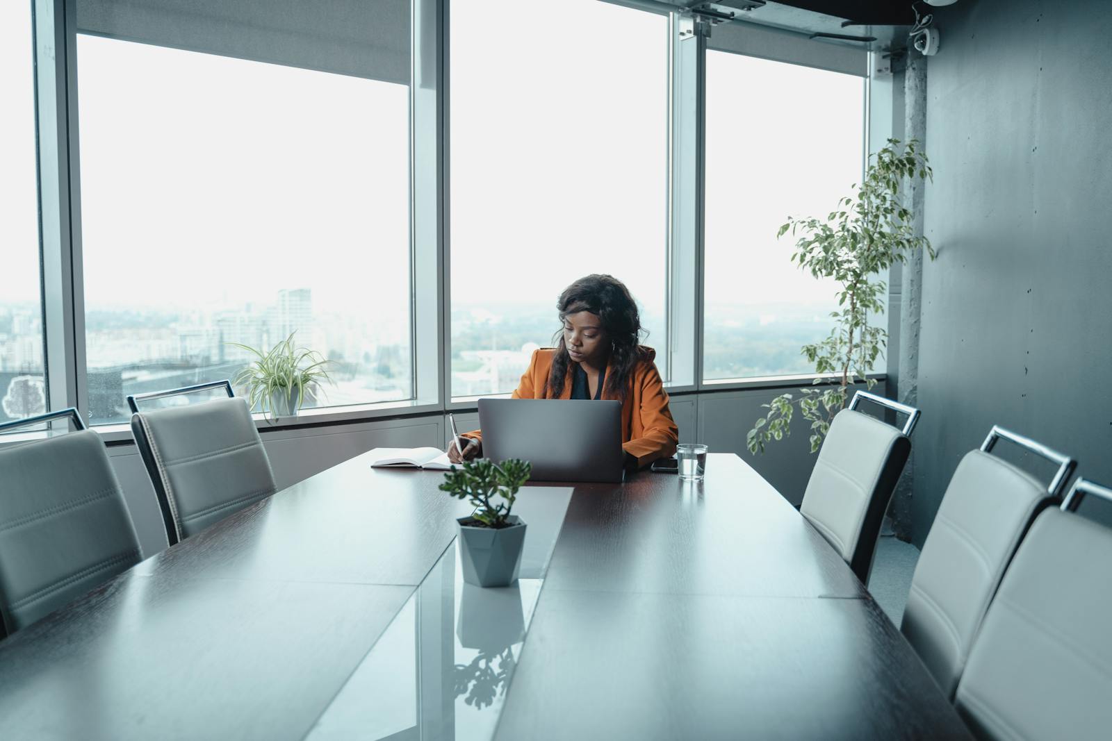Professional woman sitting alone in conference room