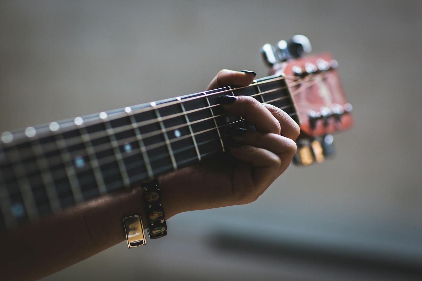 hands playing guitar close-up