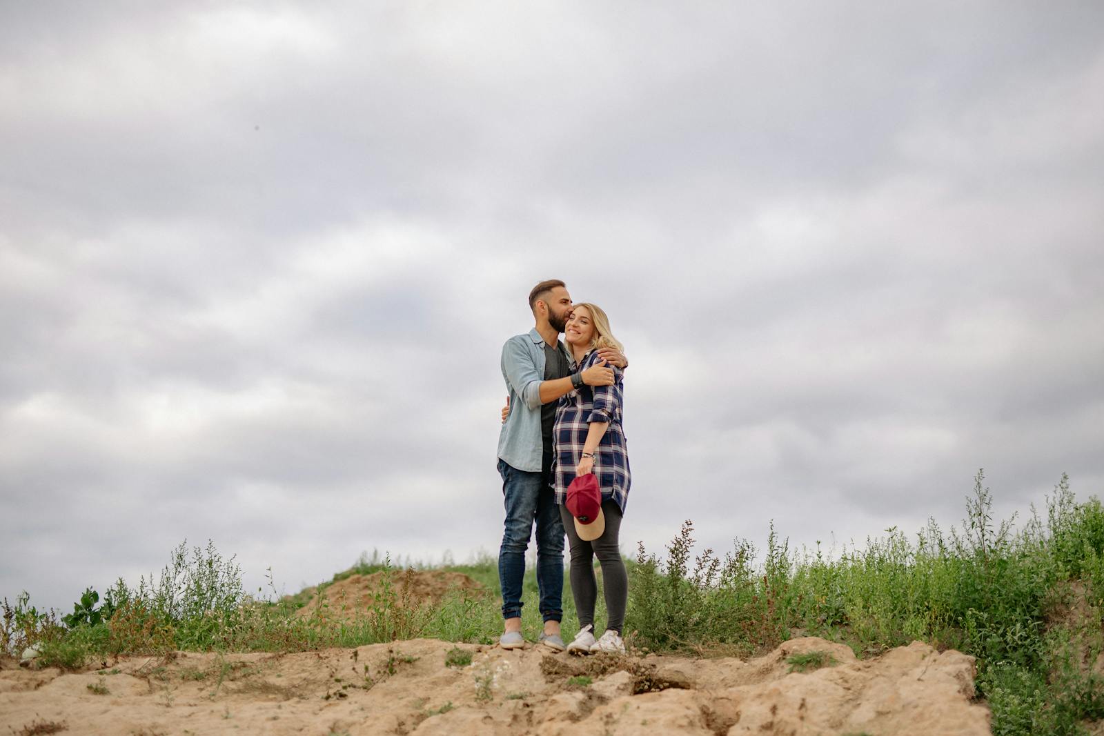 two people embracing looking away