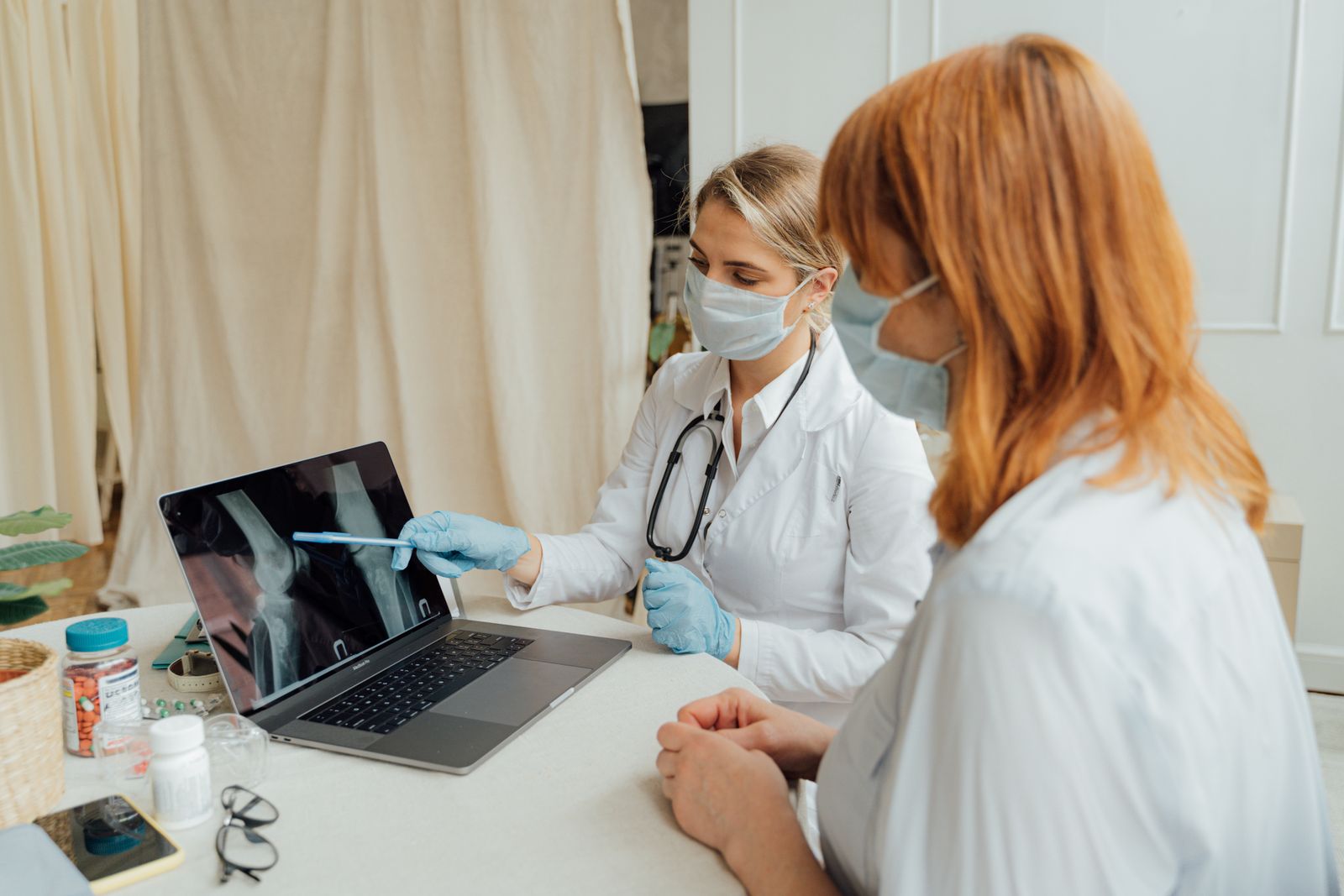 Doctors reviewing an X-ray image on a laptop