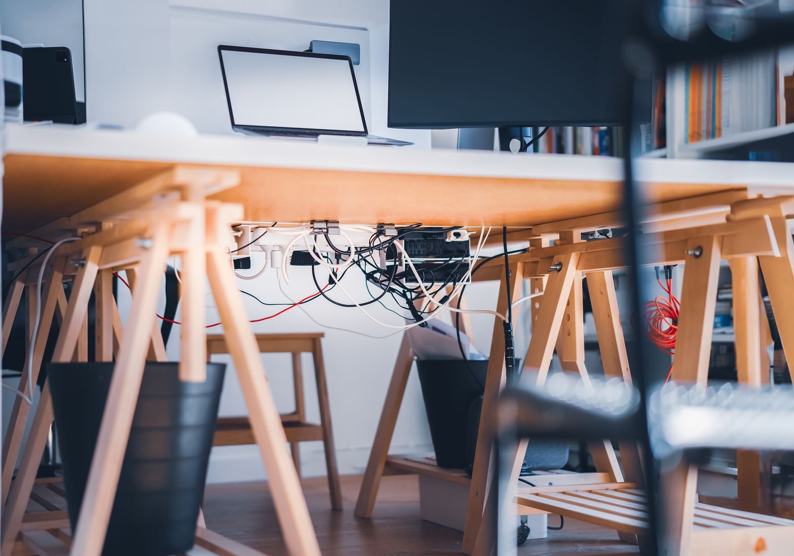 workspace with laptop, monitor and visible cables