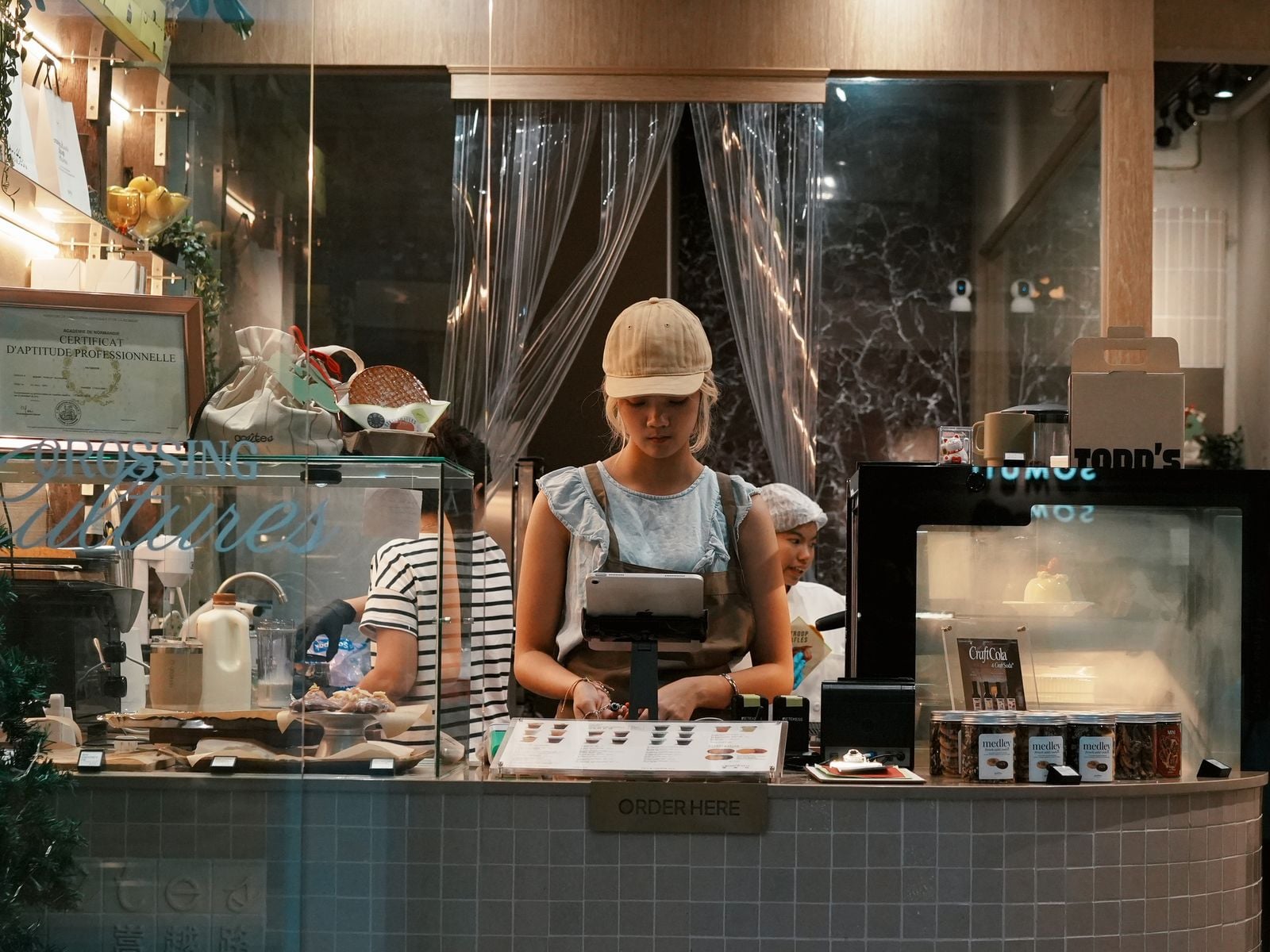 young woman working at a modern bakery counter