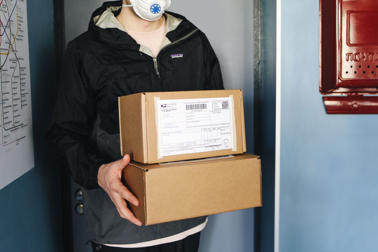 delivery worker holding cardboard boxes