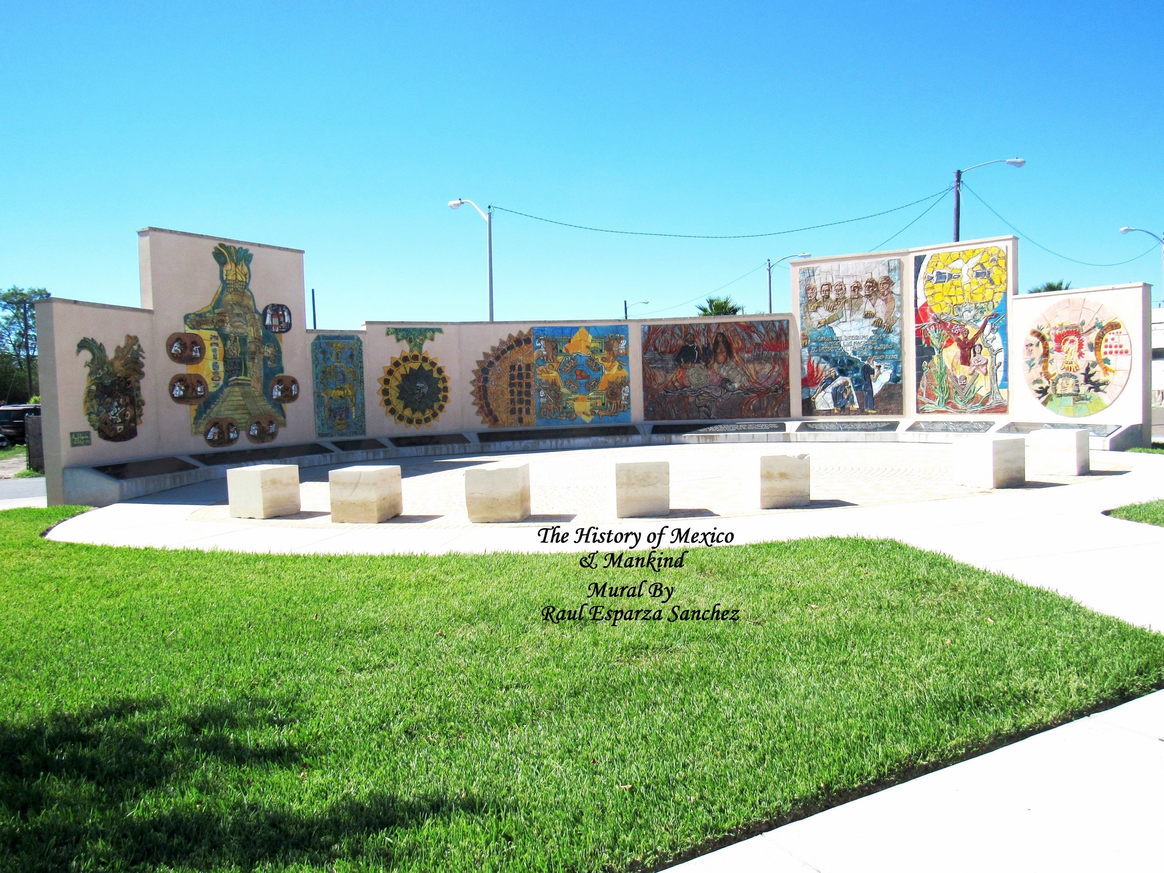Street view in Harlingen, Texas, showing a mural and downtown buildings under a blue sky